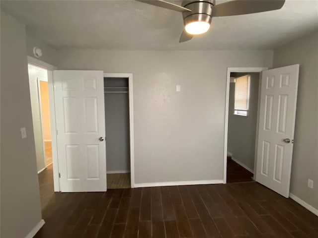 unfurnished bedroom with dark hardwood / wood-style flooring, a closet, and ceiling fan