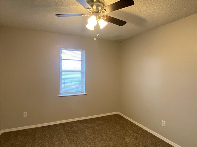 carpeted spare room featuring ceiling fan and a textured ceiling