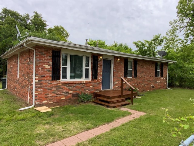 ranch-style home featuring brick siding and a front lawn