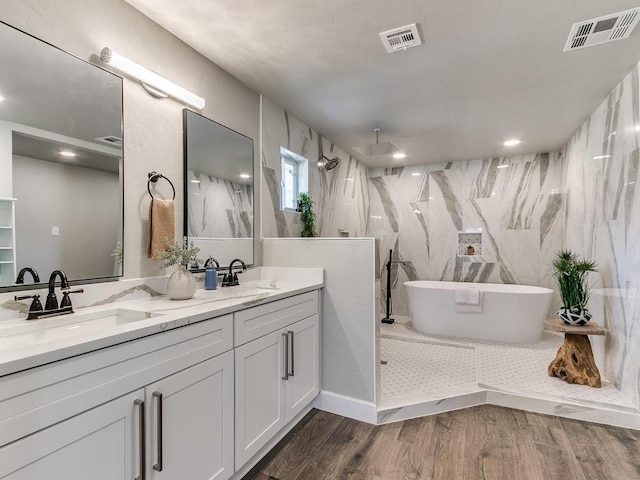 bathroom with vanity, hardwood / wood-style flooring, and shower with separate bathtub