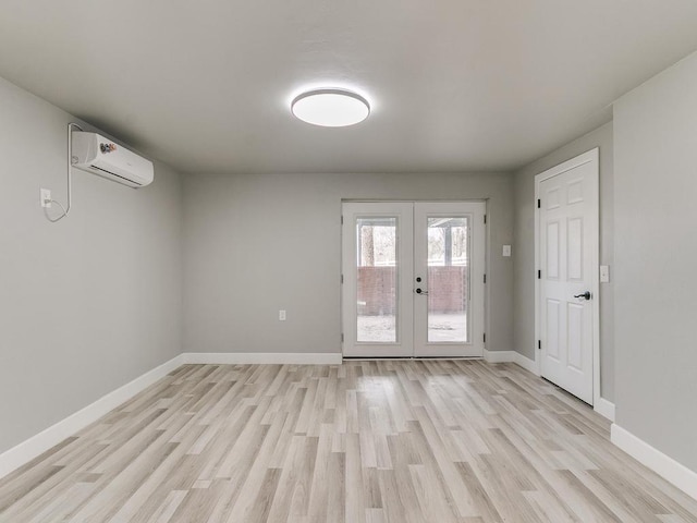 doorway to outside with a wall mounted air conditioner, french doors, and light wood-type flooring