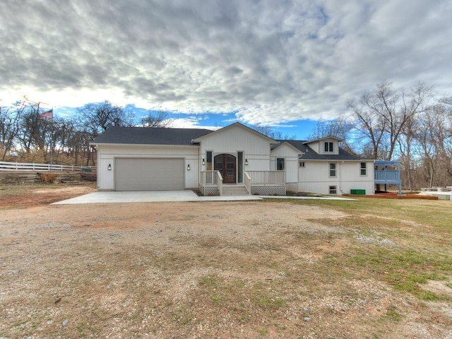 view of front of property with a garage and a front lawn