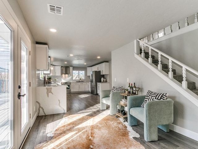 living room with dark hardwood / wood-style floors and sink