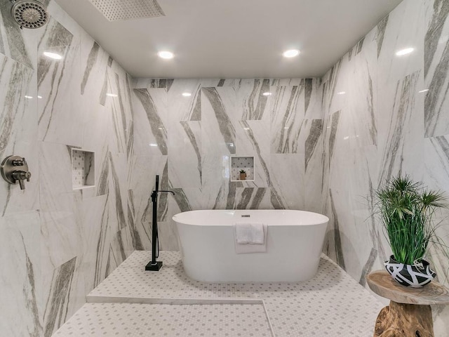 bathroom with shower with separate bathtub, tile patterned flooring, and tile walls