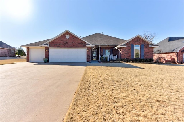 ranch-style house featuring an attached garage, driveway, a front yard, and brick siding