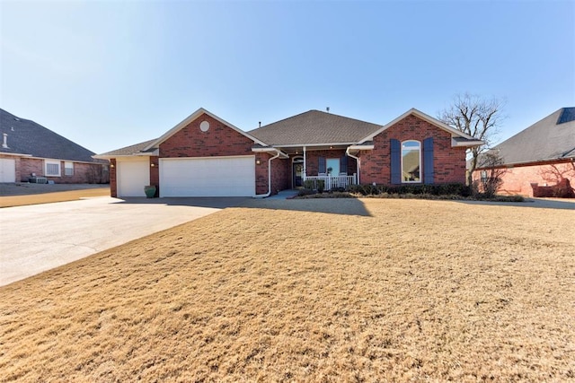 ranch-style house with covered porch, driveway, brick siding, and an attached garage