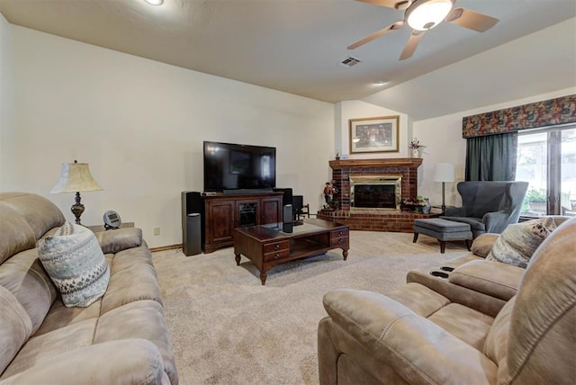 living room with visible vents, a ceiling fan, light colored carpet, vaulted ceiling, and a brick fireplace