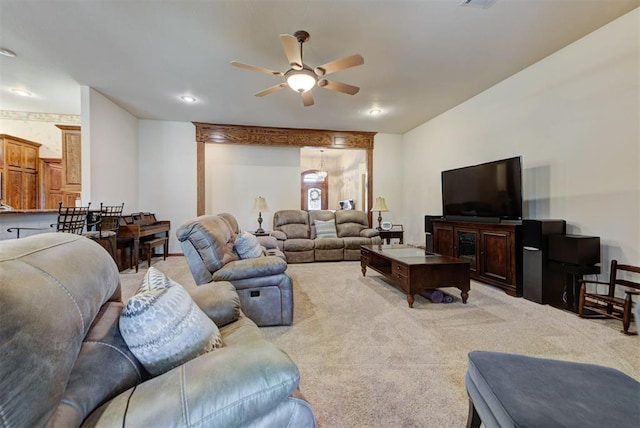 living room with light carpet, ceiling fan, and visible vents