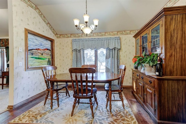 dining room with dark wood finished floors and wallpapered walls