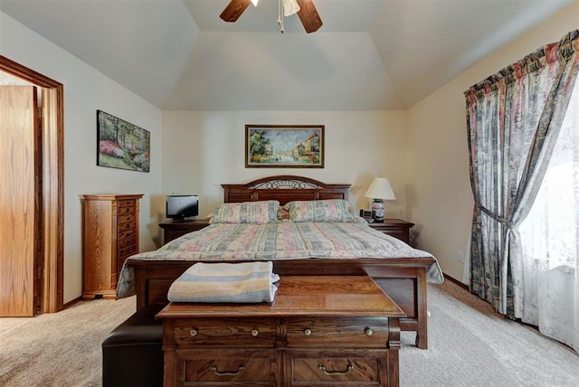 bedroom featuring lofted ceiling, a ceiling fan, and light colored carpet