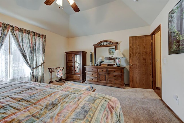 bedroom with lofted ceiling, baseboards, carpet floors, and a ceiling fan