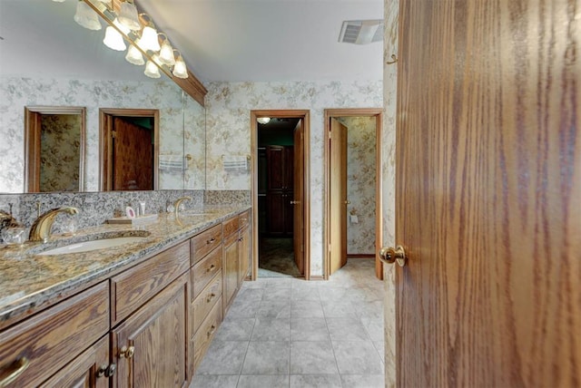 full bathroom with tile patterned flooring, visible vents, a sink, and wallpapered walls