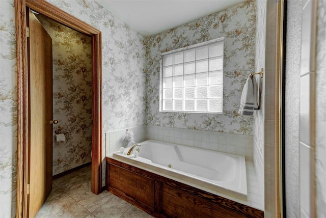 bathroom featuring baseboards, tile patterned floors, a bath, and wallpapered walls