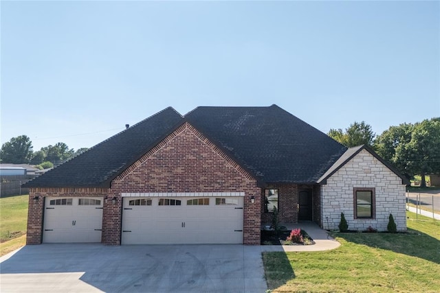 view of front of home featuring a garage and a front yard