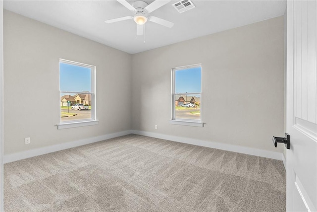 unfurnished room featuring ceiling fan and carpet floors