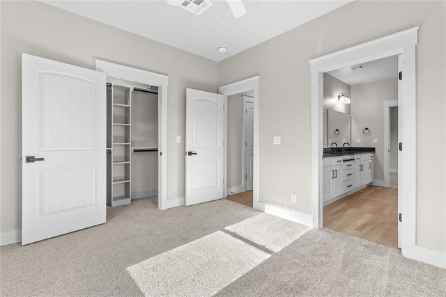 carpeted bedroom featuring ceiling fan and a closet