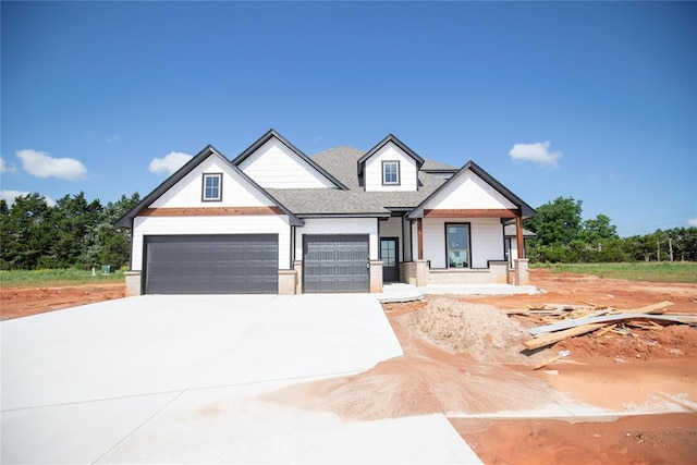 3105 Feather Dr, Yukon, OK 73099 - modern farmhouse with driveway, an attached garage, covered porch, and a shingled roof