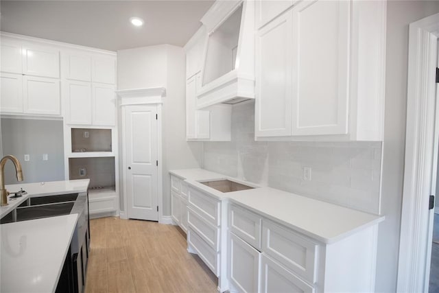 3105 Feather Dr, Yukon, OK 73099 - kitchen with custom range hood, backsplash, white cabinetry, light wood finished floors, and recessed lighting