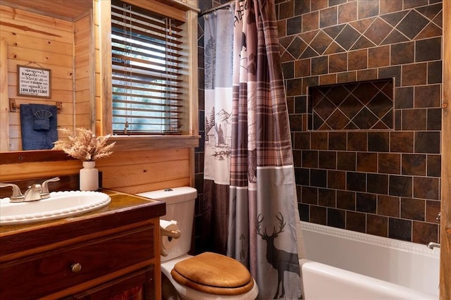 full bathroom with vanity, shower / tub combo with curtain, wooden walls, and toilet