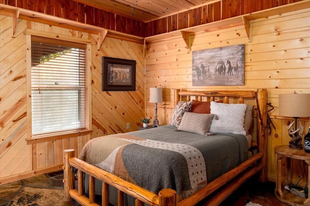 bedroom with wooden ceiling and wood walls