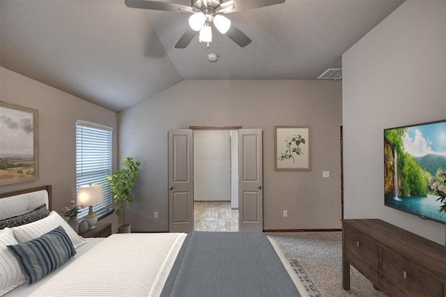 bedroom featuring vaulted ceiling, light carpet, and ceiling fan