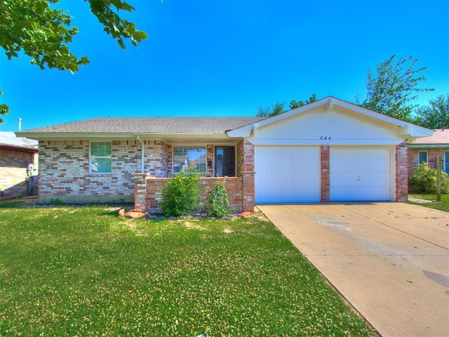 single story home featuring a garage and a front lawn