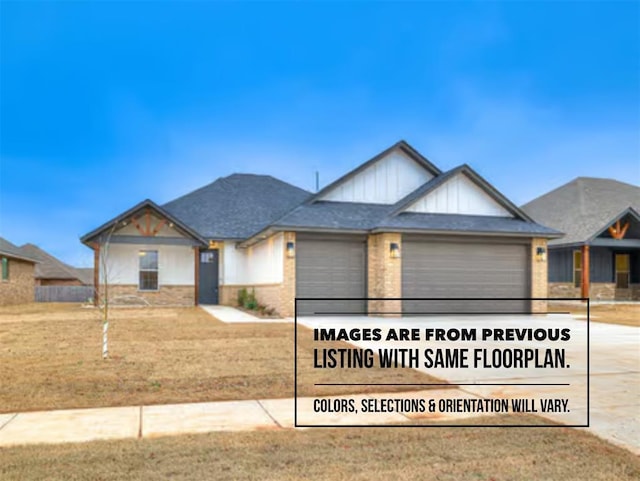 view of front of property featuring a garage and a front lawn