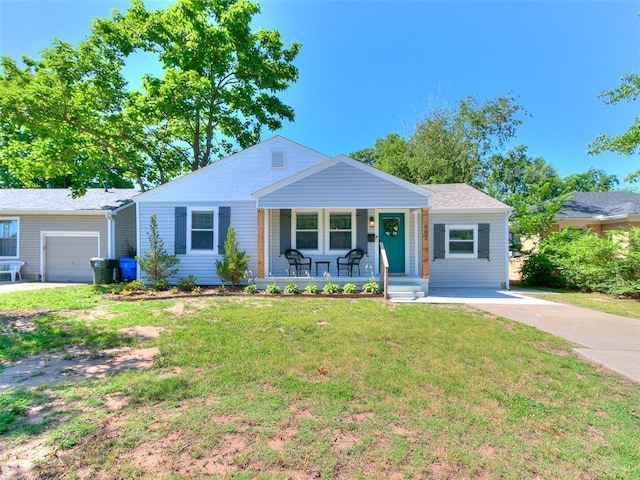 single story home with a porch, a garage, and a front yard