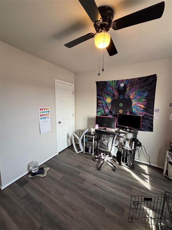 interior space with dark wood-type flooring and ceiling fan