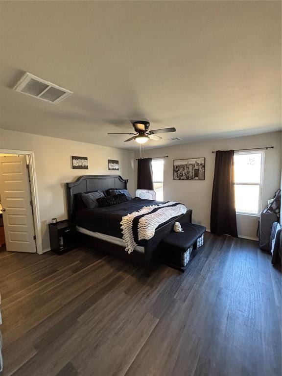 bedroom with dark hardwood / wood-style flooring and ceiling fan