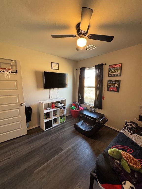 living room featuring dark wood-type flooring and ceiling fan