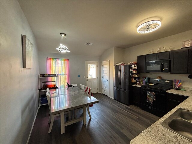 kitchen with pendant lighting, sink, black appliances, and dark hardwood / wood-style floors