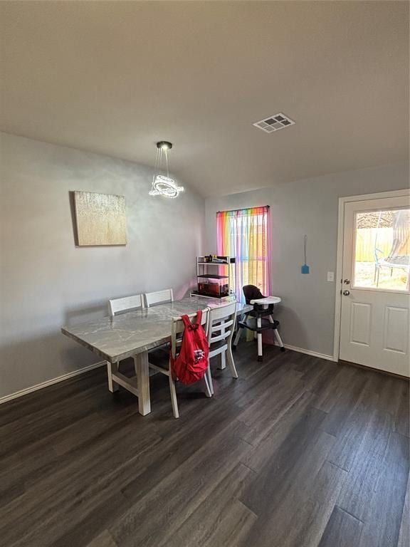 dining area featuring a healthy amount of sunlight and dark wood-type flooring