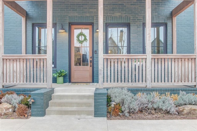 view of exterior entry with a porch