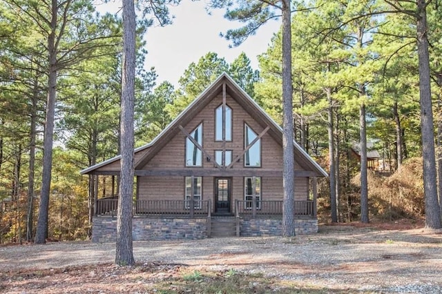 log-style house with covered porch