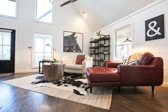 living room featuring dark wood-type flooring, high vaulted ceiling, and ceiling fan