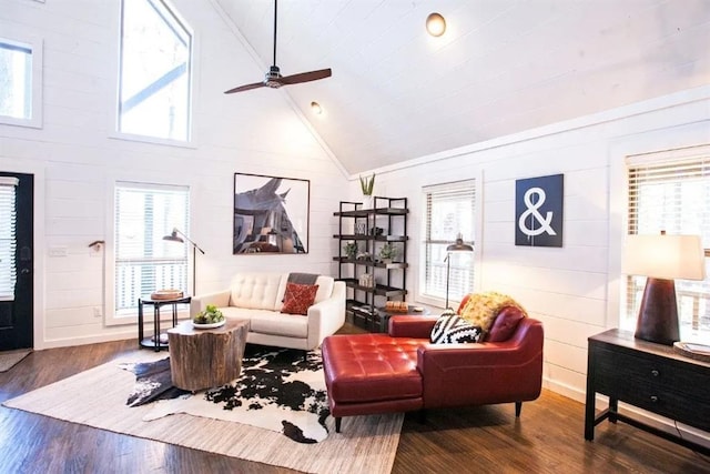 living room with ceiling fan, dark hardwood / wood-style floors, and high vaulted ceiling