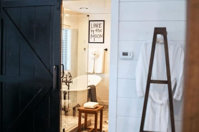 bathroom featuring a bathing tub and tile walls