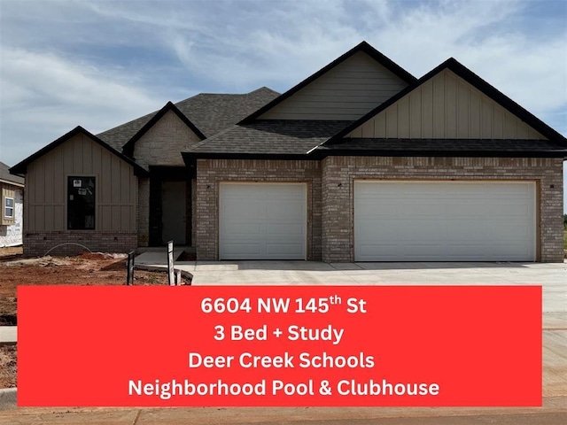 view of front of house featuring brick siding, a garage, roof with shingles, board and batten siding, and driveway