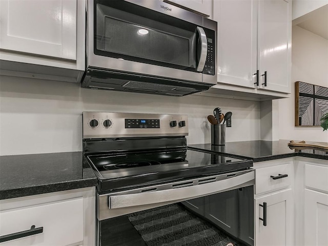 kitchen featuring stainless steel appliances and white cabinetry