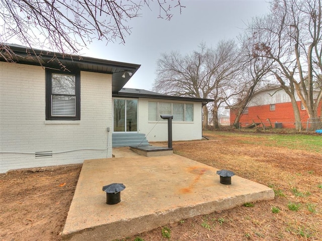 rear view of house featuring a patio area and a lawn