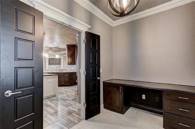 office area with crown molding and a sink