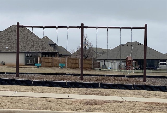 view of yard with playground community and fence