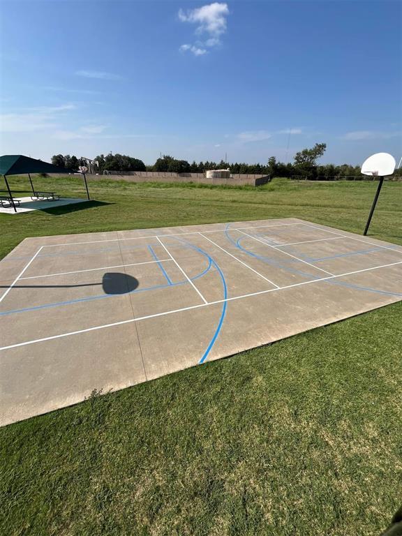 view of basketball court featuring community basketball court and a lawn