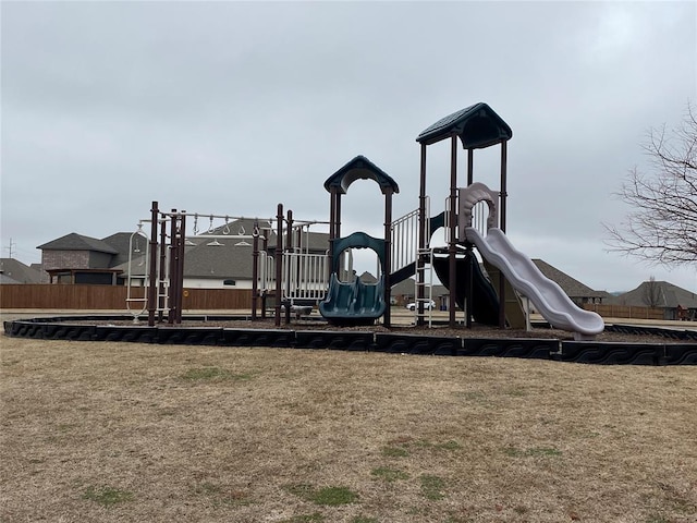 community playground with fence and a lawn