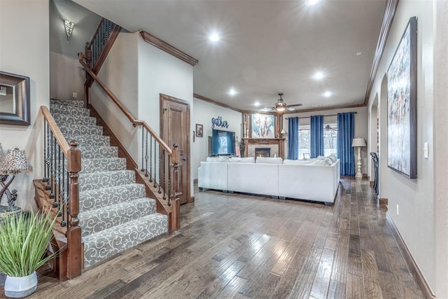 living room featuring crown molding, ceiling fan, and hardwood / wood-style floors