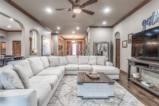 living room with ornamental molding, hardwood / wood-style floors, and ceiling fan