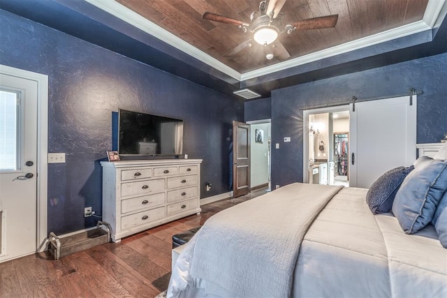 bedroom featuring dark hardwood / wood-style flooring, ornamental molding, wood ceiling, a tray ceiling, and a barn door