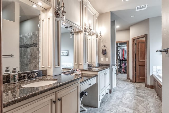 bathroom with vanity and shower with separate bathtub