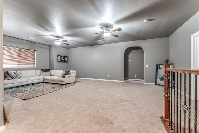 carpeted living room featuring ceiling fan